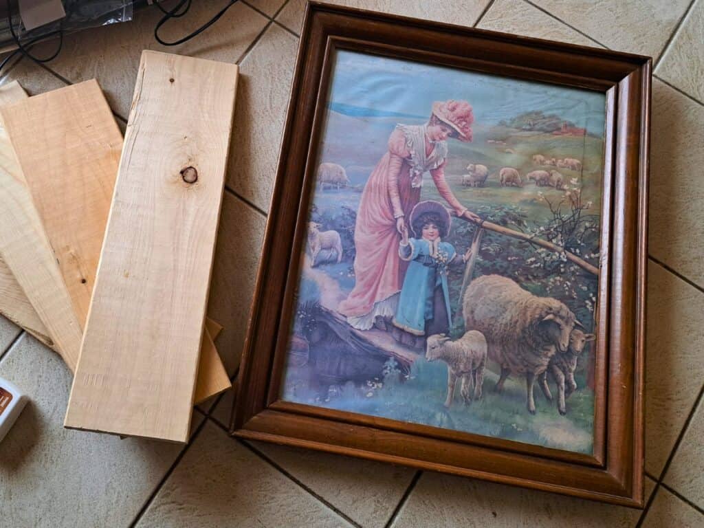 Old picture frame and wooden 1x6 boards cut to make a kitchen wall herb garden.