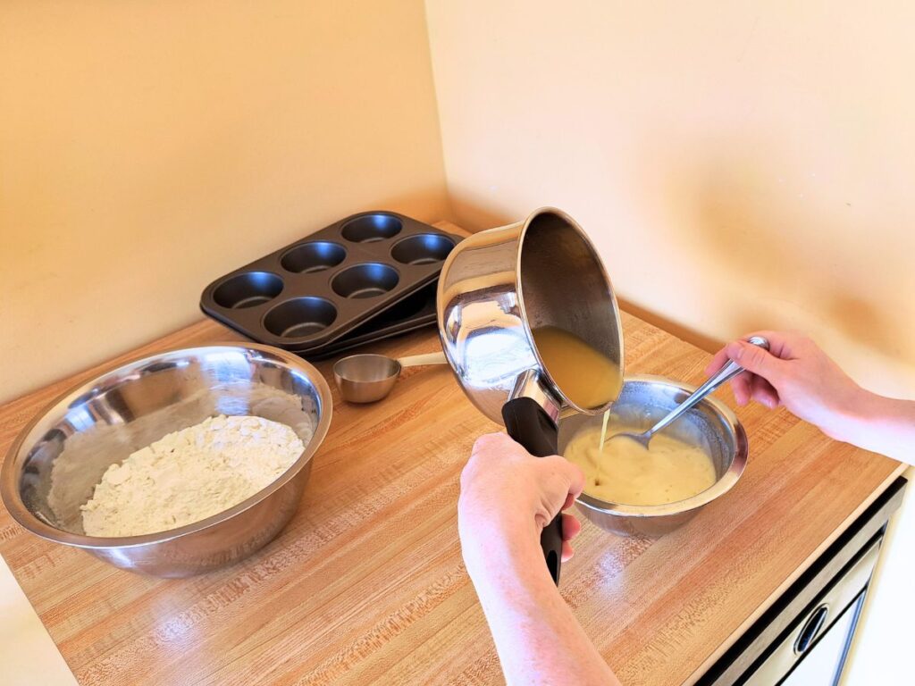 Adding the infused chamomile mixture to the sourdough starter.
