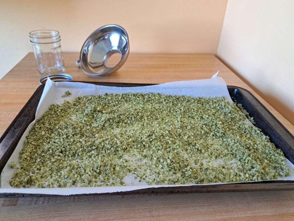 Dried herb infused salt cooling on the counter on a baking sheet.