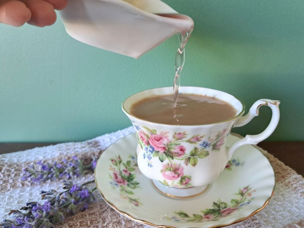 Adding light syrup to a cup of tea.