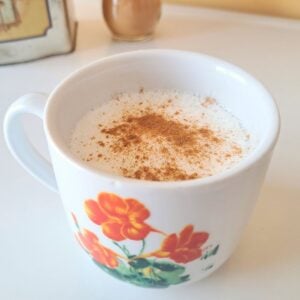 A mug of chamomile moon milk sitting on a counter.