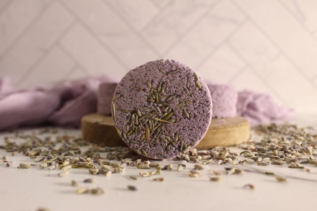 A close up of a lavender shower steamer.