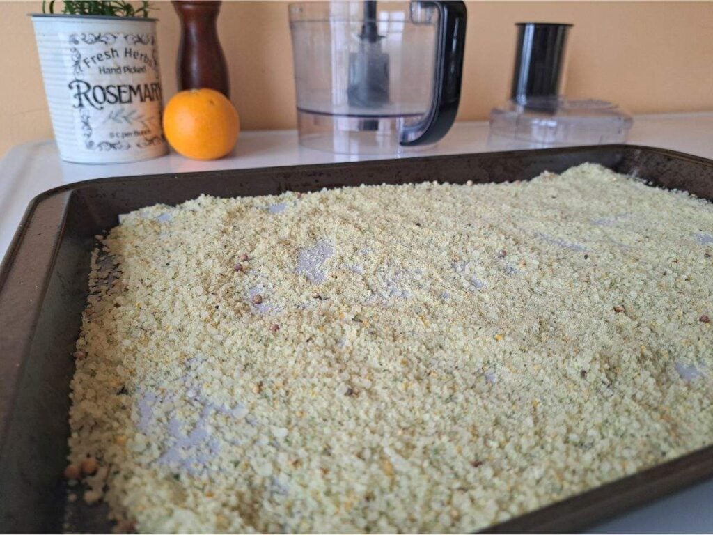 Rosemary orange salt cooling on the counter on a baking sheet.